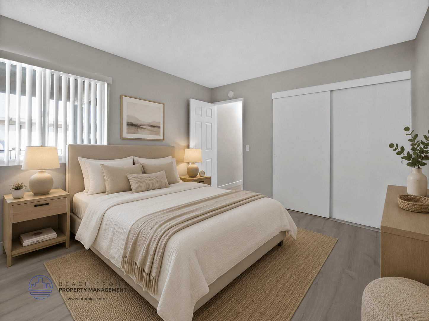 A bedroom with a large bed, a nightstand, and a chair.